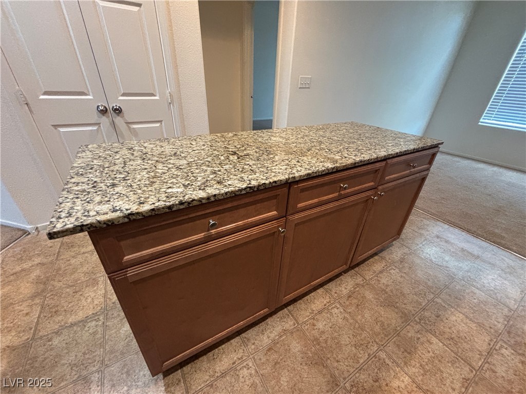 4512 Townwall Street Las Vegas, NV 89115 - Photo 21 of 56 Kitchen with a center island and light colored carpet