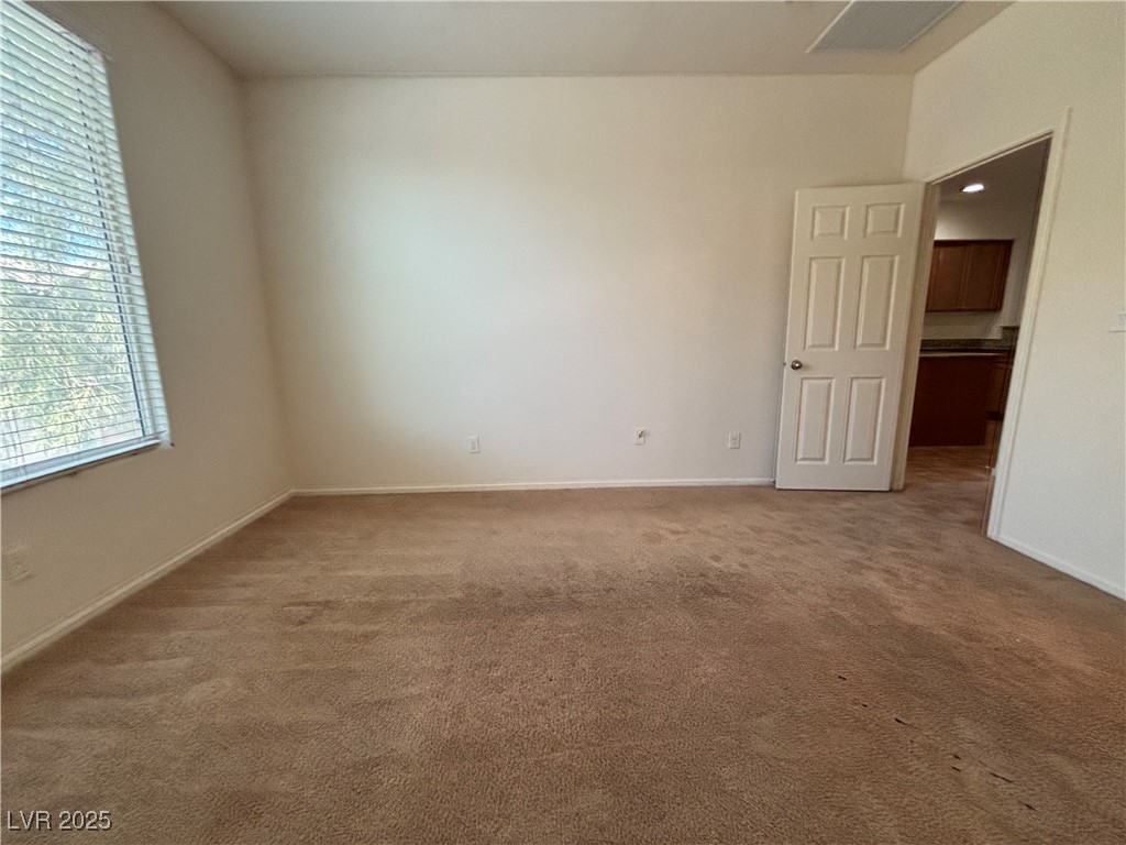 4512 Townwall Street Las Vegas, NV 89115 - Photo 24 of 56 Empty room with carpet floors and baseboards