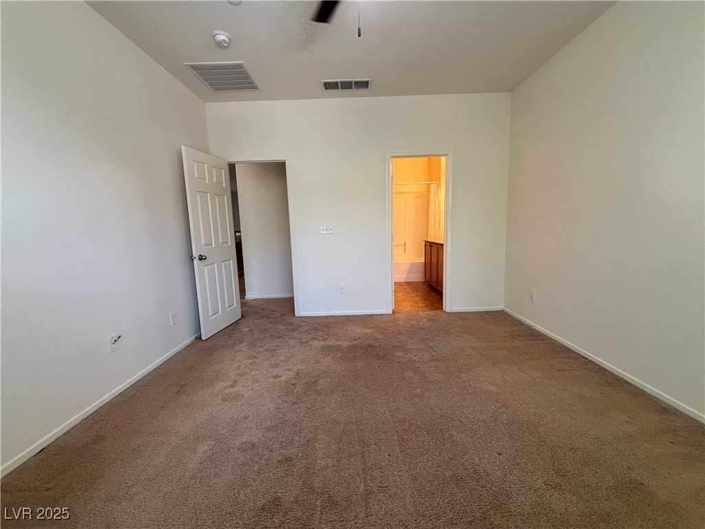 4512 Townwall Street Las Vegas, NV 89115 - Photo 25 of 56 Unfurnished bedroom with carpet floors, ensuite bathroom, and a ceiling fan