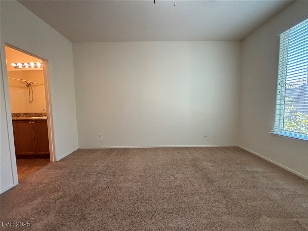 4512 Townwall Street Las Vegas, NV 89115 - Photo 26 of 56 Unfurnished bedroom with dark colored carpet and ensuite bath