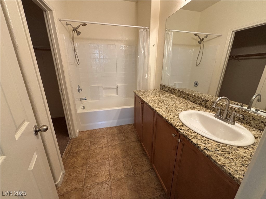 4512 Townwall Street Las Vegas, NV 89115 - Photo 29 of 56 Full bath with shower / bath combination with curtain, vanity, and a walk in closet