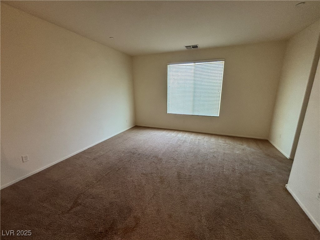 4512 Townwall Street Las Vegas, NV 89115 - Photo 33 of 56 Carpeted spare room featuring baseboards