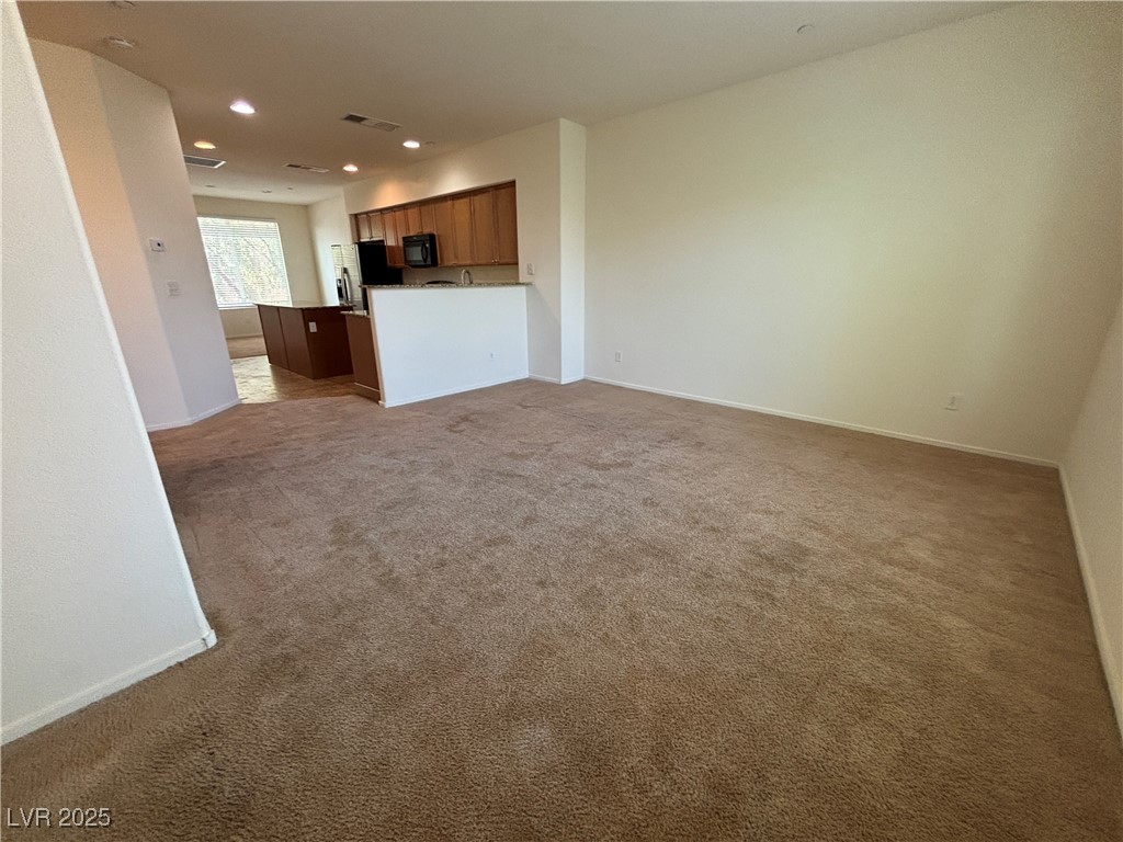4512 Townwall Street Las Vegas, NV 89115 - Photo 36 of 56 Unfurnished living room with dark carpet and recessed lighting