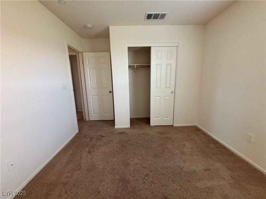 4512 Townwall Street Las Vegas, NV 89115 - Photo 44 of 56 Unfurnished bedroom with dark colored carpet and a closet