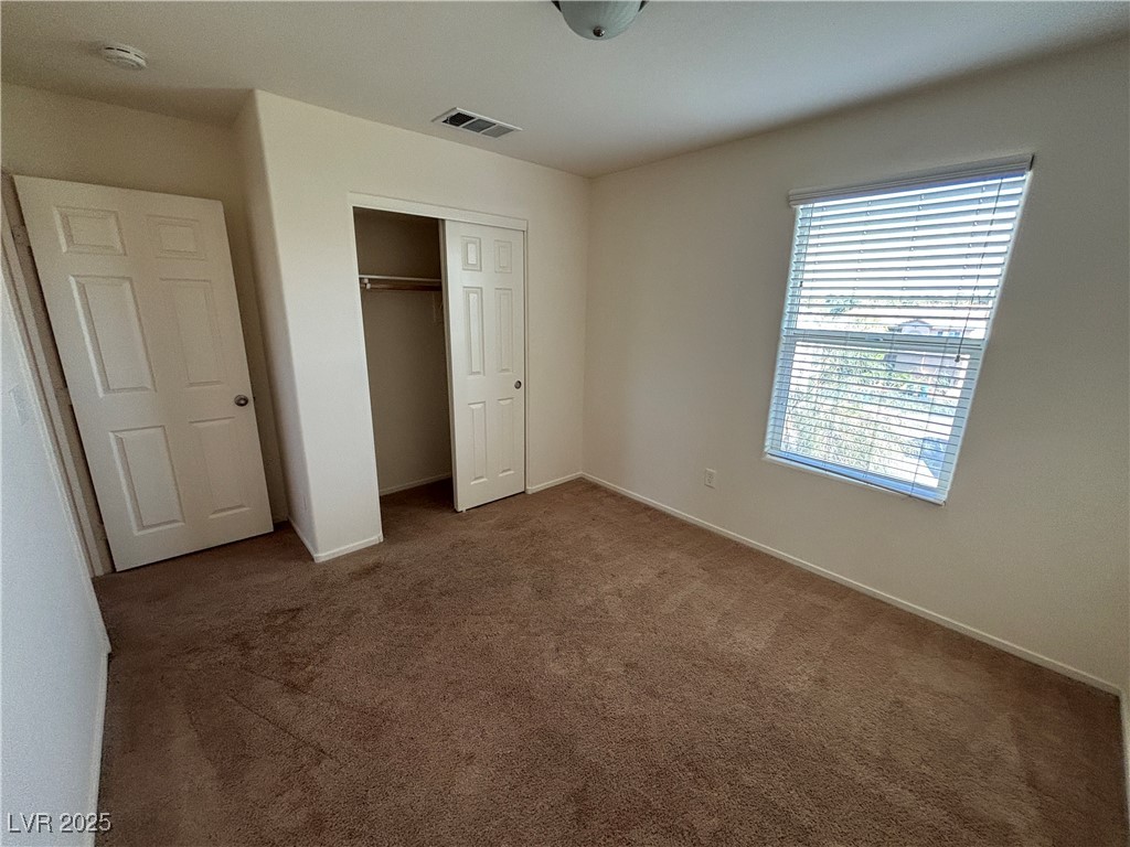 4512 Townwall Street Las Vegas, NV 89115 - Photo 45 of 56 Unfurnished bedroom with dark colored carpet and a closet