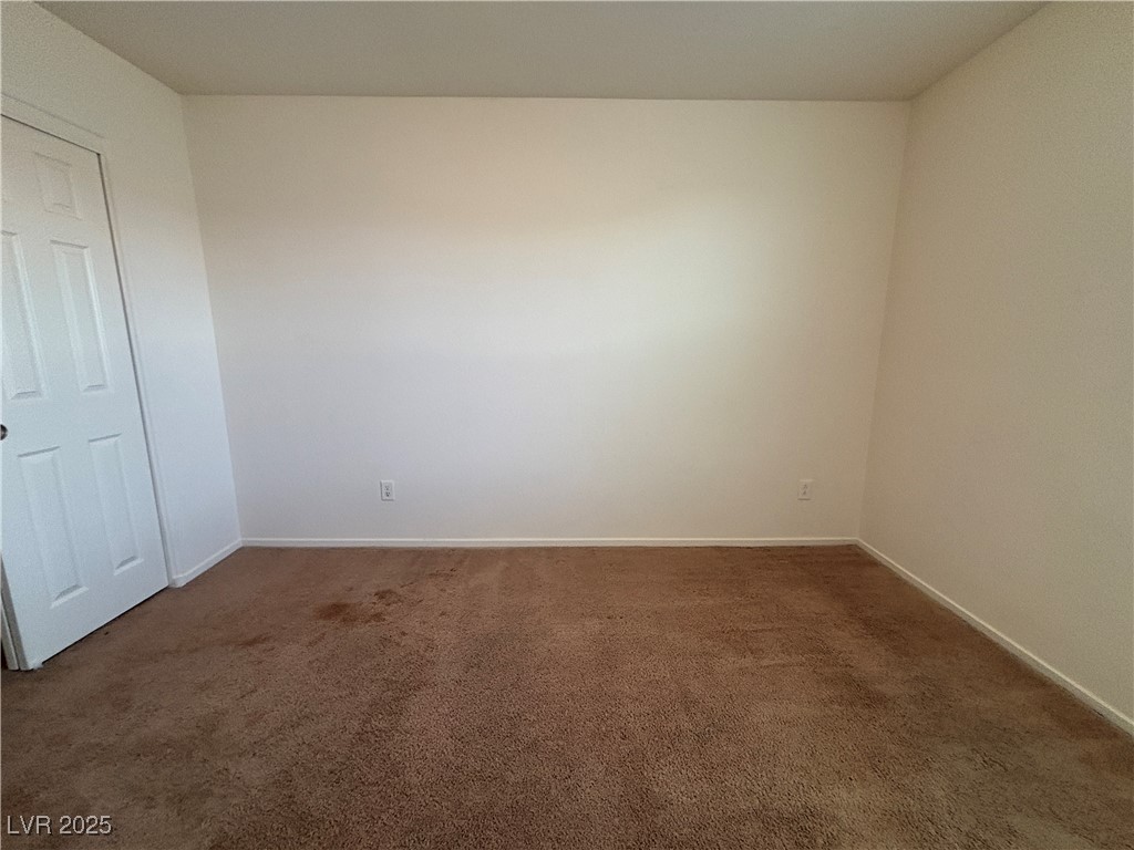 4512 Townwall Street Las Vegas, NV 89115 - Photo 49 of 56 Spare room featuring dark carpet and baseboards