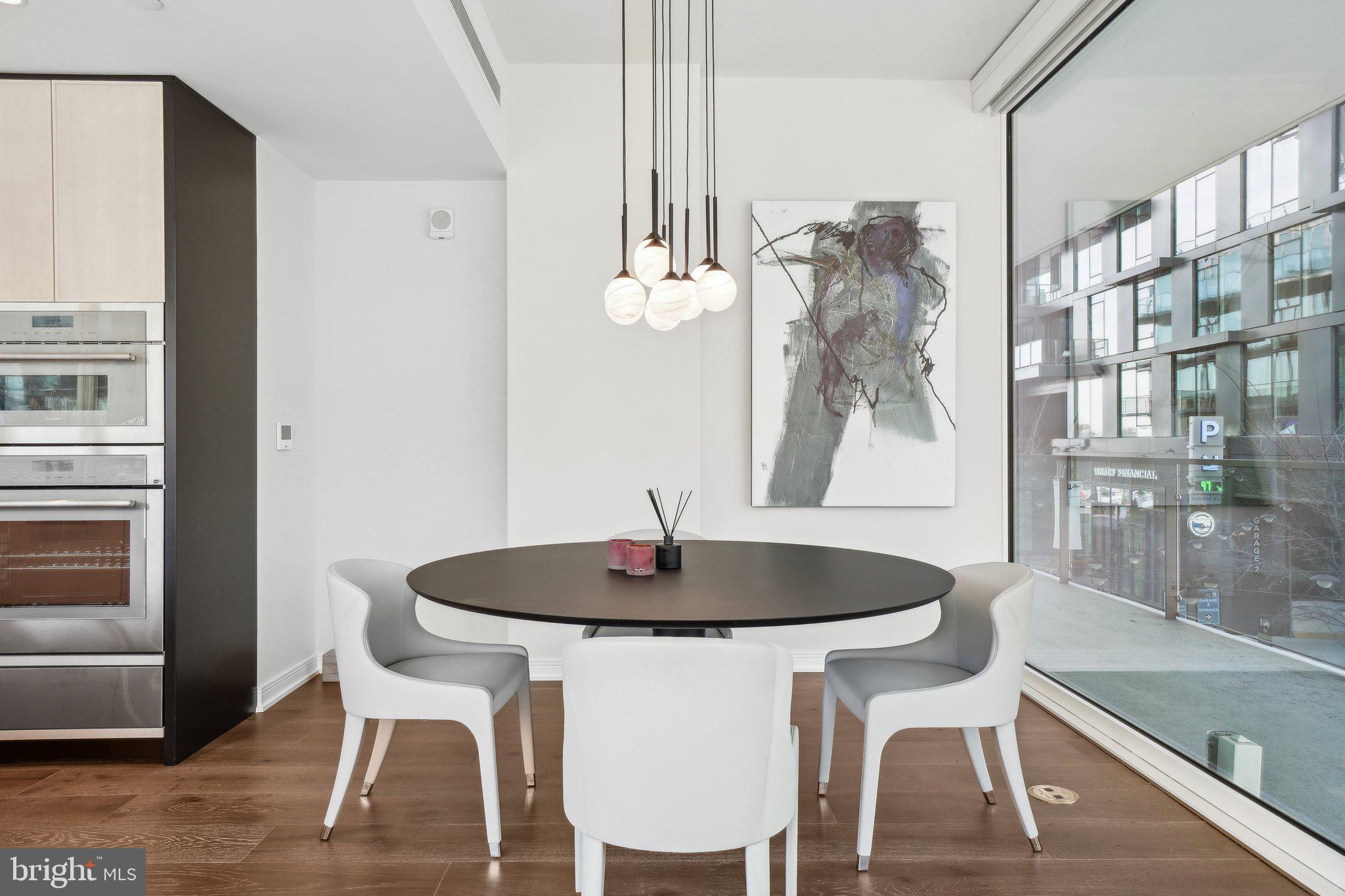 601 Wharf Street Southwest, Unit 213 Washington, DC 20024 - Photo 11 of 23 a dining room with a table and chairs