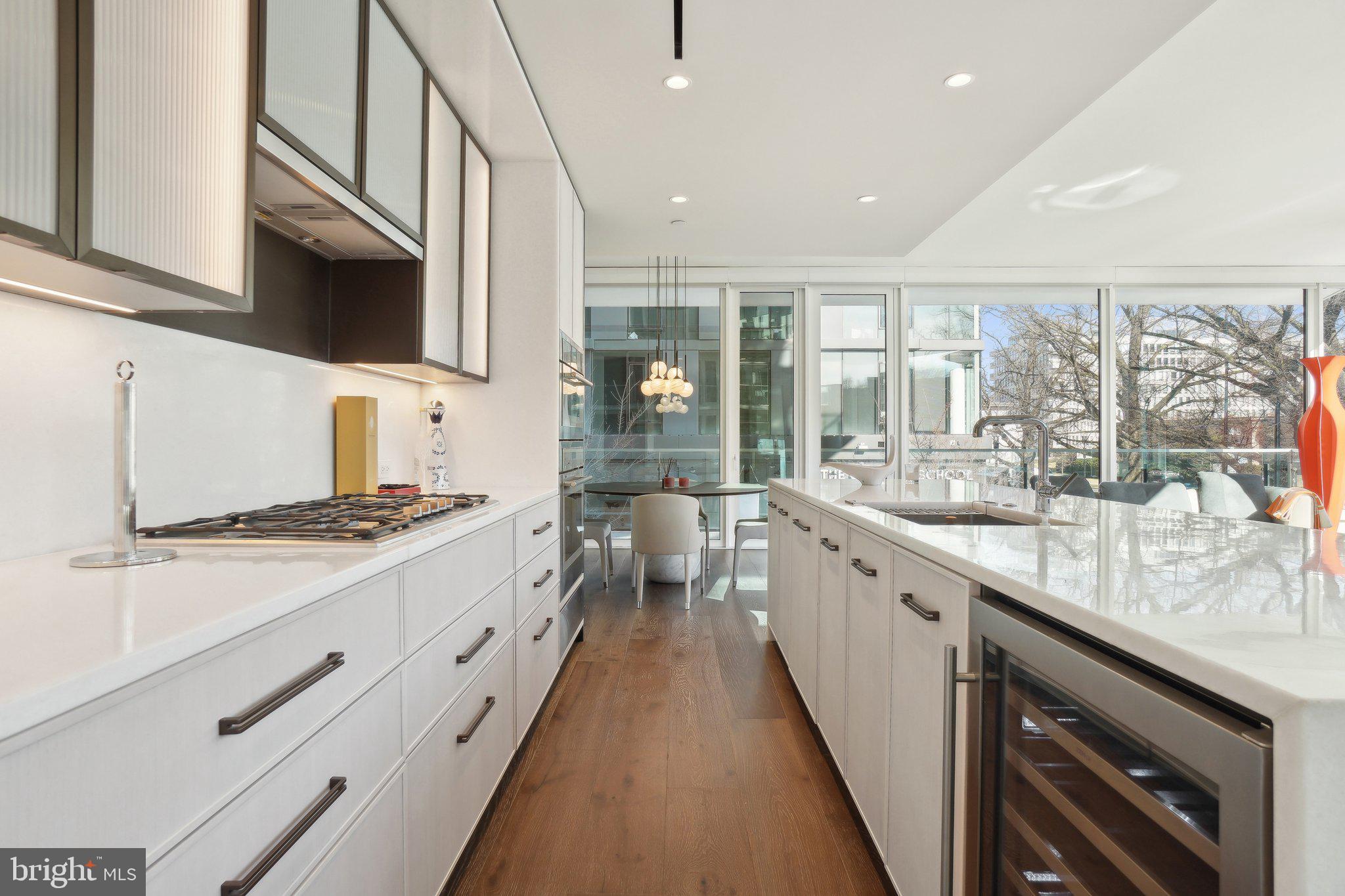 601 Wharf Street Southwest, Unit 213 Washington, DC 20024 - Photo 6 of 23 a large kitchen with stainless steel appliances granite countertop a stove and a sink