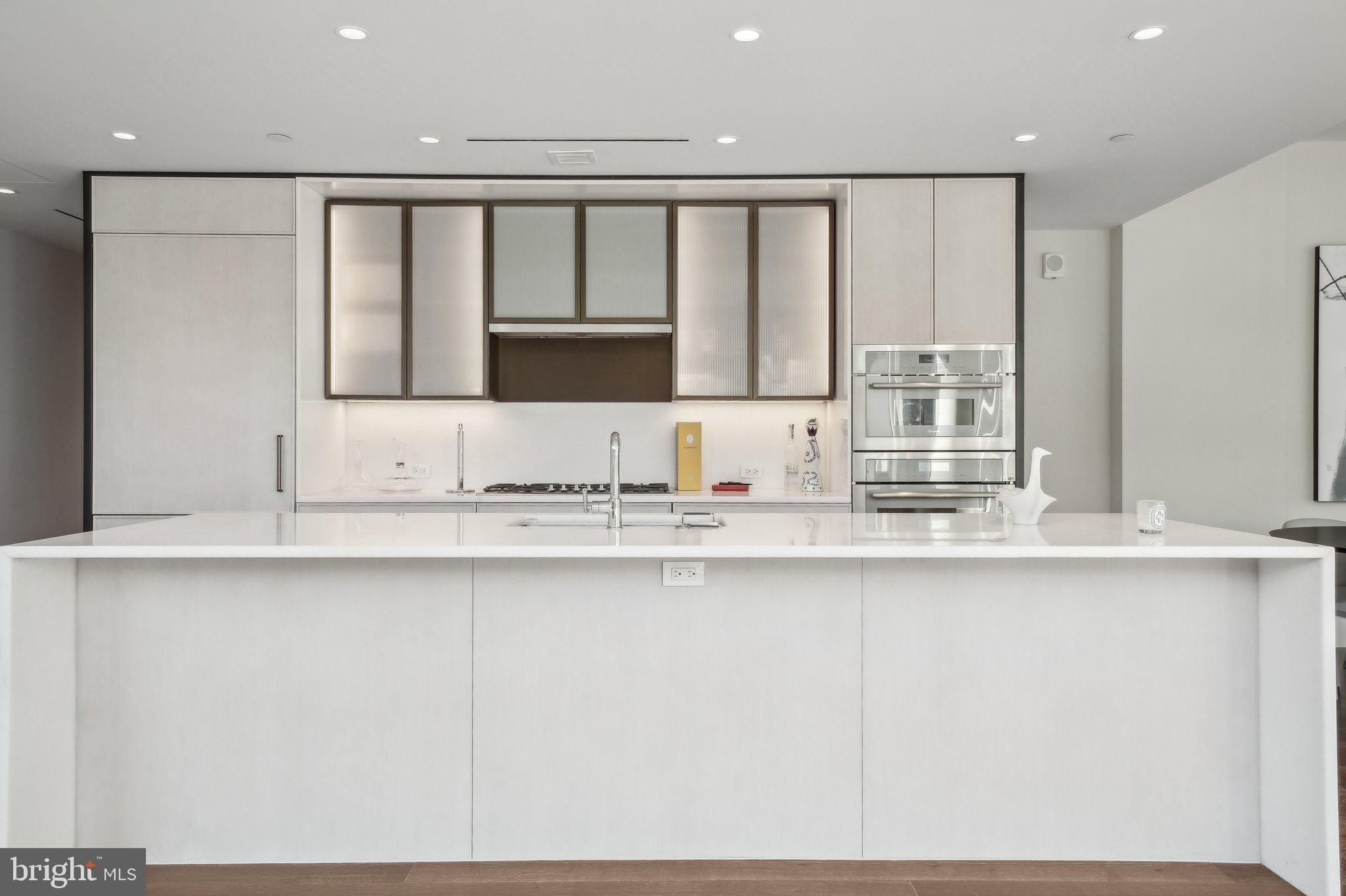 601 Wharf Street Southwest, Unit 213 Washington, DC 20024 - Photo 9 of 23 a kitchen with stainless steel appliances granite countertop a sink and a white cabinets