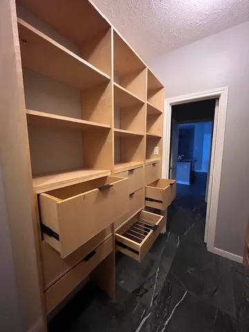 a room with gym equipment and wooden floor