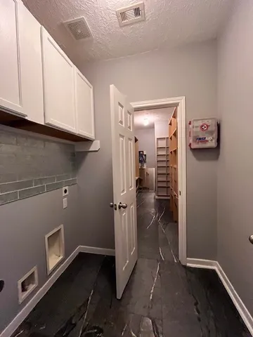 a view of a storage & utility room with a sink