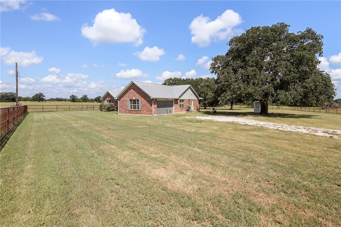 7808 Oxford Cemetery Road Madisonville, TX 77864 - Photo 18 of 41 a view of a house with a big yard and large trees
