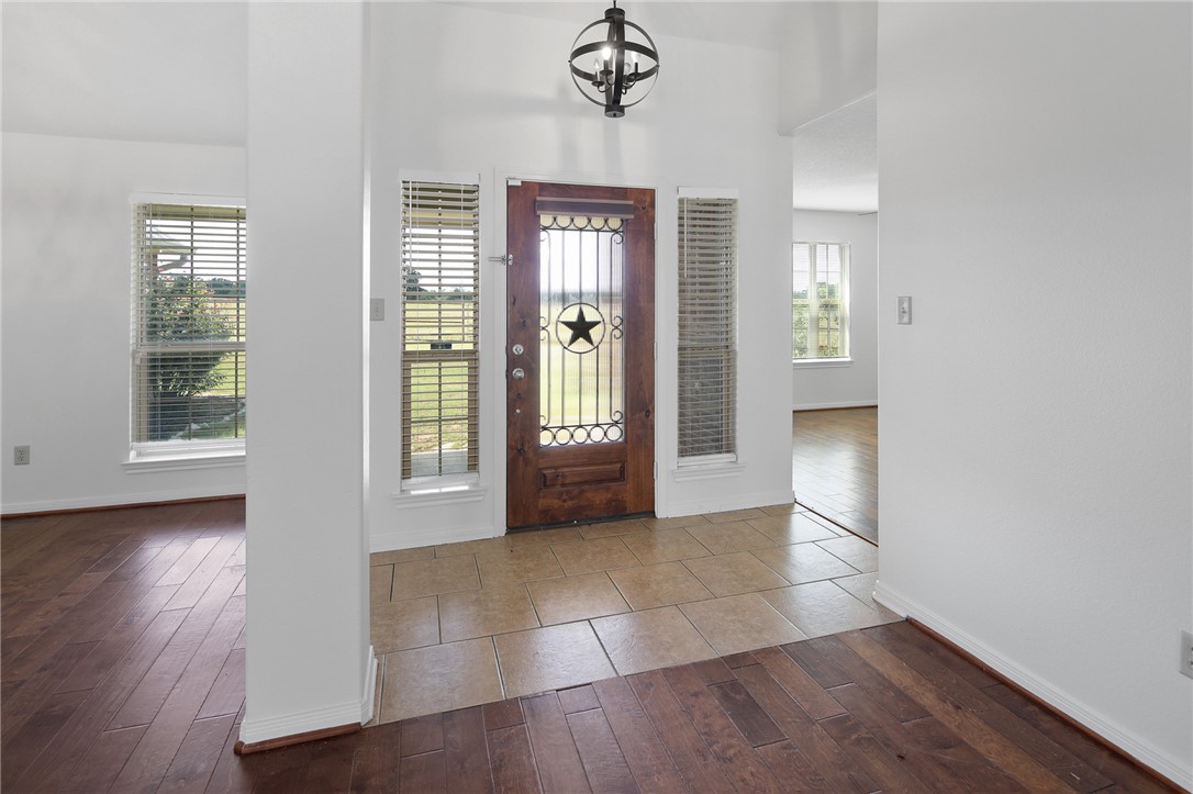 7808 Oxford Cemetery Road Madisonville, TX 77864 - Photo 19 of 41 a view of an empty room with wooden floor and a window