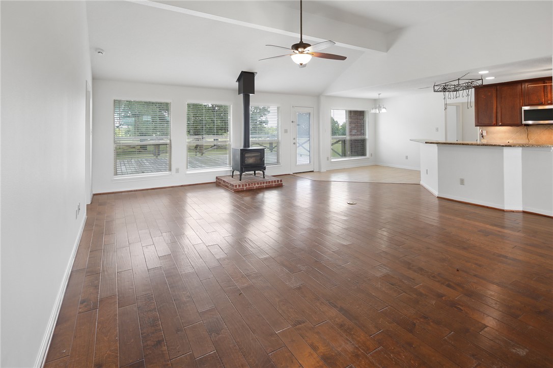 7808 Oxford Cemetery Road Madisonville, TX 77864 - Photo 21 of 41 a view of an empty room with wooden floor and a window