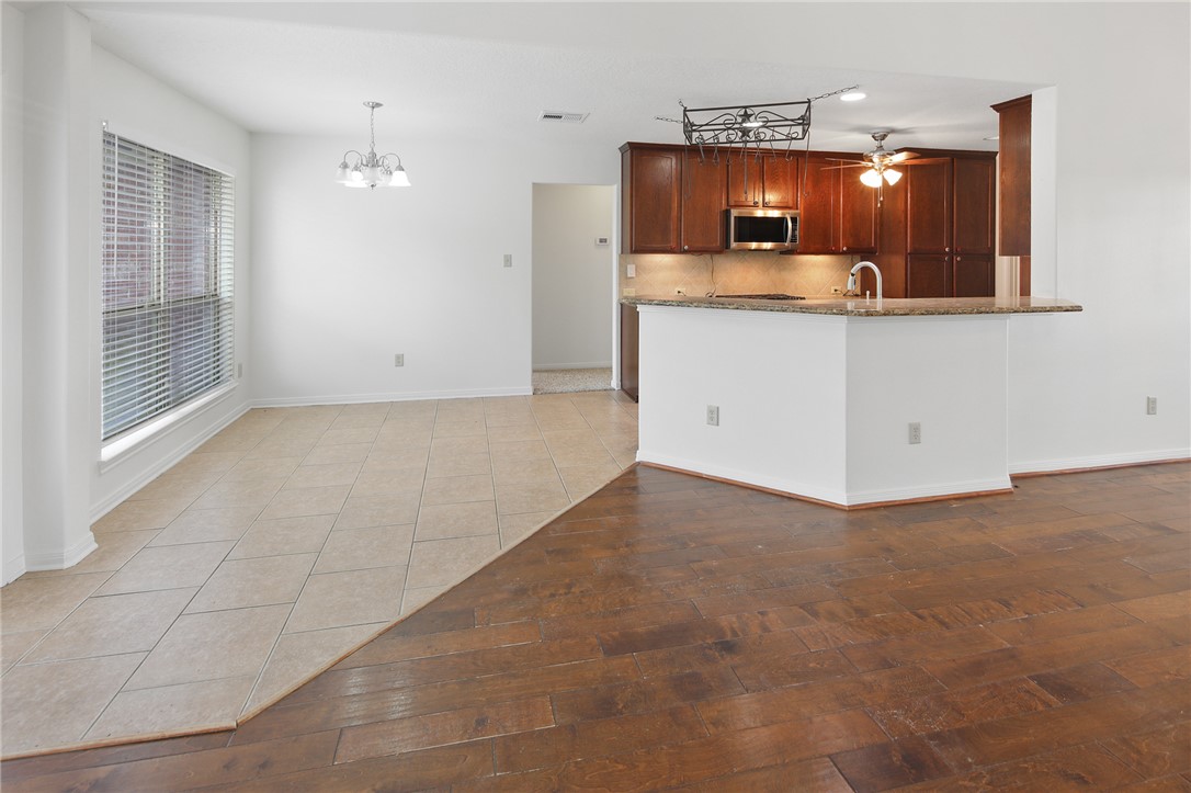 7808 Oxford Cemetery Road Madisonville, TX 77864 - Photo 25 of 41 Kitchen with light tile patterned floors, a chande