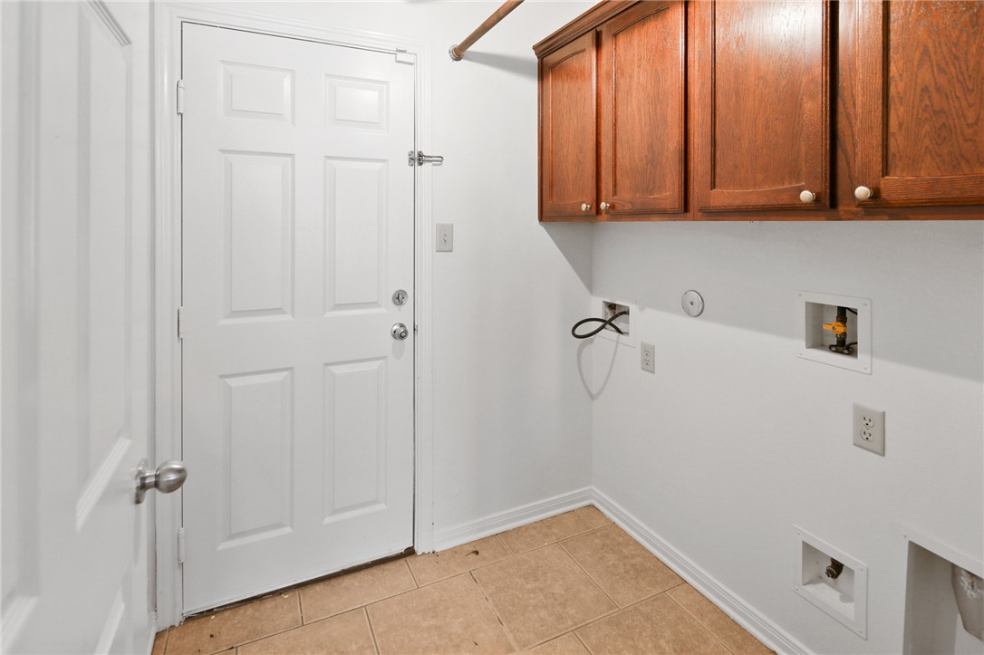 7808 Oxford Cemetery Road Madisonville, TX 77864 - Photo 29 of 41 Laundry room featuring washer hookup, light tile p