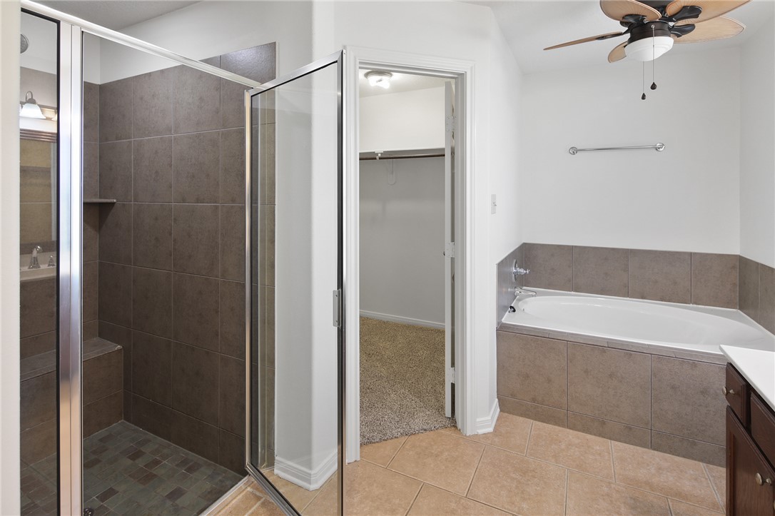 7808 Oxford Cemetery Road Madisonville, TX 77864 - Photo 32 of 41 a bathroom with a tub and shower