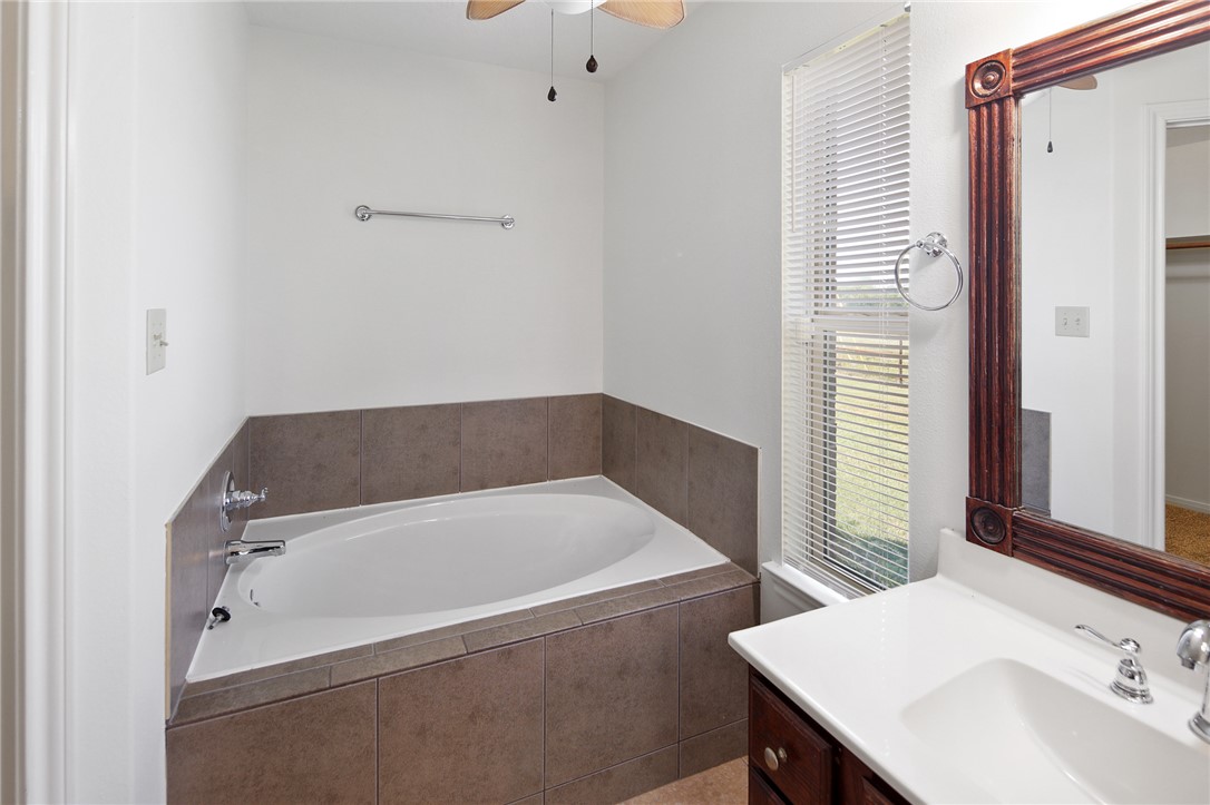7808 Oxford Cemetery Road Madisonville, TX 77864 - Photo 34 of 41 Full bath with a garden tub, vanity, and ceiling f