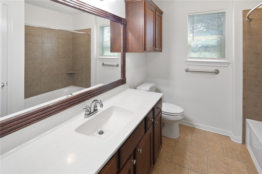 7808 Oxford Cemetery Road Madisonville, TX 77864 - Photo 38 of 41 a bathroom with a sink a toilet and shower