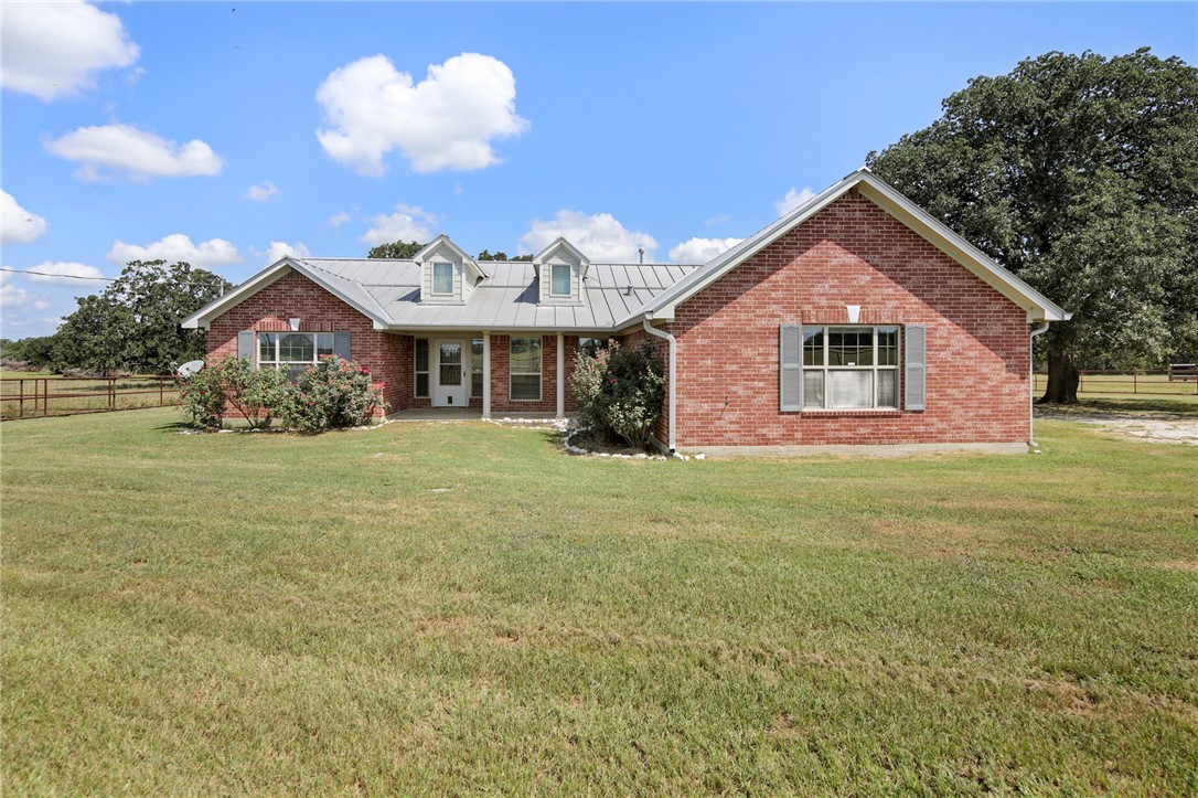 7808 Oxford Cemetery Road Madisonville, TX 77864 - Photo 5 of 41 a front view of a house with garden