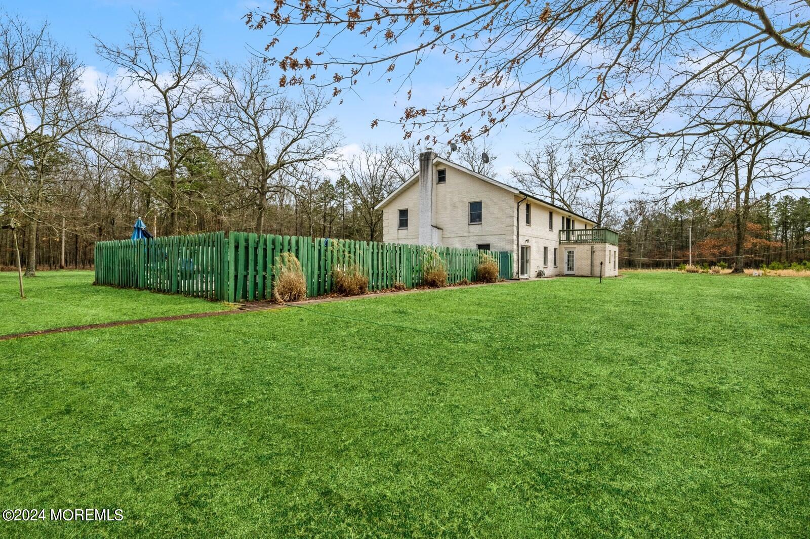 105 Buckingham Road Whiting, NJ 08759 - Photo 8 of 59 a view of a yard with a house and garden