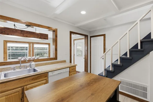 a view of a kitchen with cabinets and wooden floor