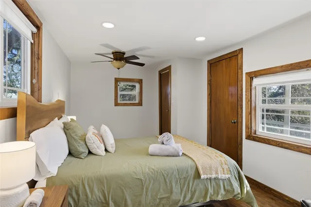 a bedroom with a bed and wooden floor
