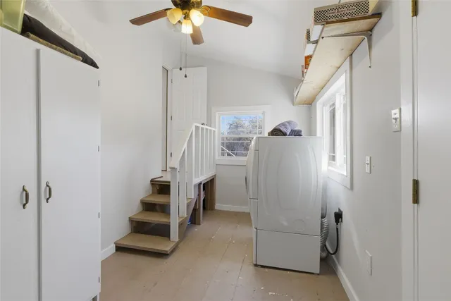 a view of a house with a yard covered in snow