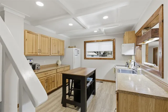 a living room with wooden floor and a large window