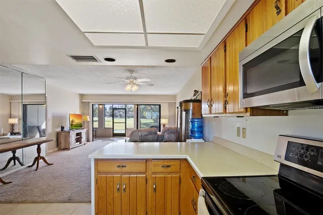 a kitchen with stainless steel appliances kitchen island granite countertop a stove and cabinets