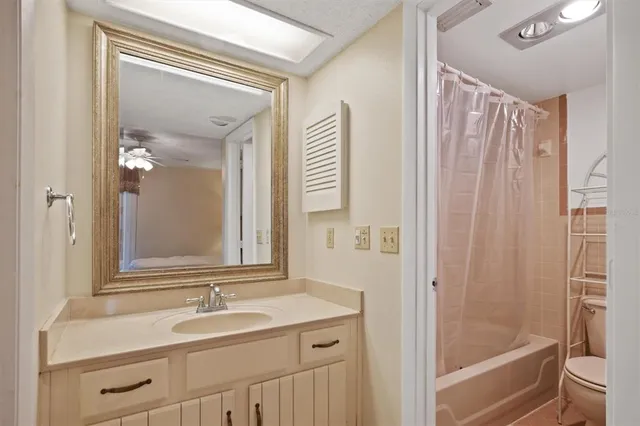 a bathroom with a sink a mirror a vanity and a shower