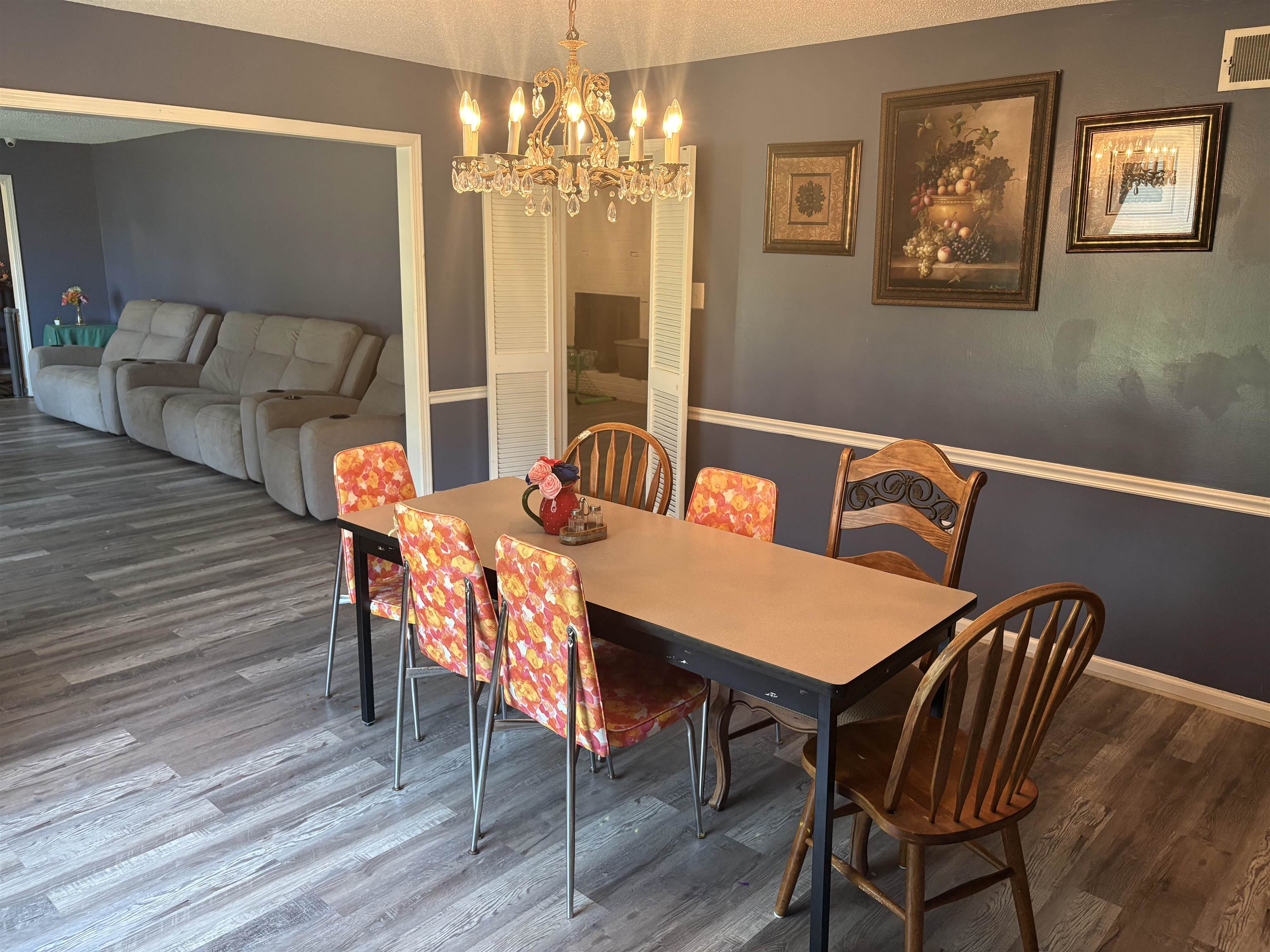 4009 Tessland Road Memphis, TN 38128 - Photo 7 of 16 Dining area featuring wood-finish flooring, a chandelier with crystal accents, and a chair rail molding