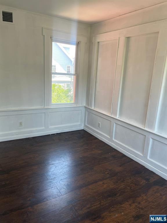 281 Renner Avenue, Unit 279 Newark, NJ 07112 - Photo 5 of 12 a view of an empty room with wooden floor and a window
