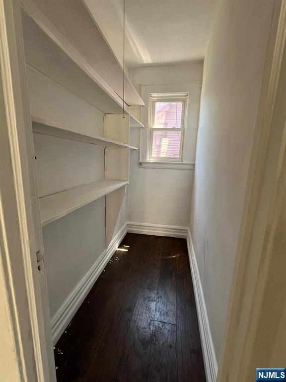281 Renner Avenue, Unit 279 Newark, NJ 07112 - Photo 10 of 12 an empty room with wooden floor and windows