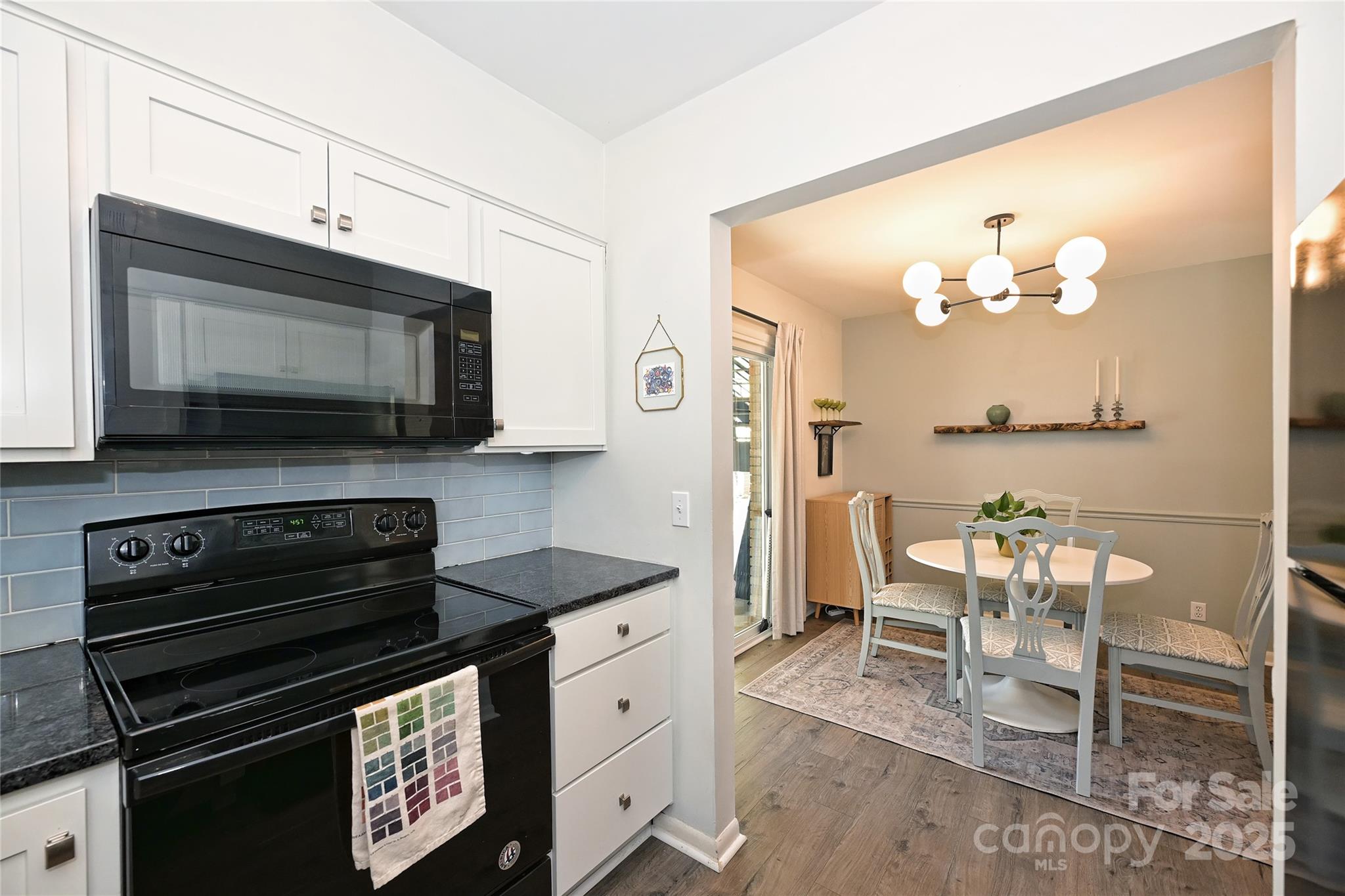 2604 Park Road, Unit B Charlotte, NC 28209 - Photo 11 of 21 a kitchen with a stove and a microwave