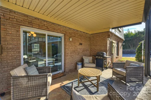 a view of a patio with table and chairs and potted plants