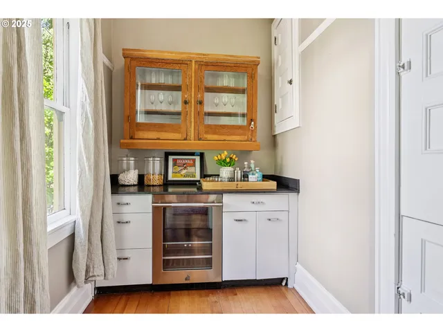 a kitchen with a stove and a white cabinet