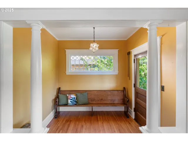 a living room with a bed and a window