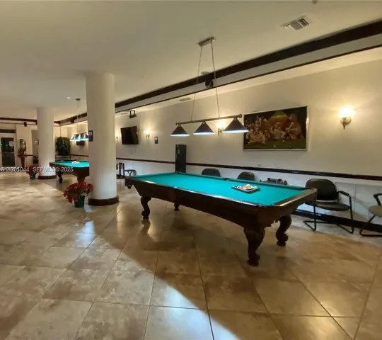 a living room with furniture pool table and a table