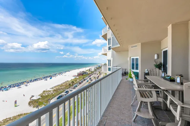 a bedroom with a large bed and a chair
