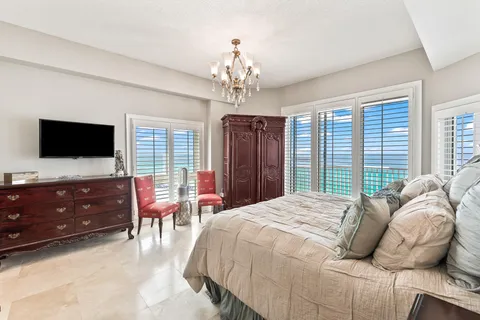 a bathroom with a granite countertop sink a mirror and shower