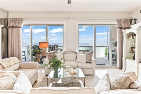 a kitchen with granite countertop a refrigerator and white cabinets