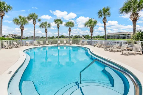 a bedroom with a bed and a potted plant on table