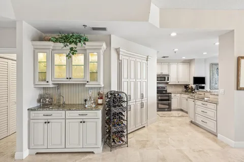 a kitchen with stainless steel appliances granite countertop a refrigerator stove and sink