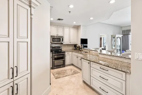 a view of a dining room with furniture wooden floor and chandelier