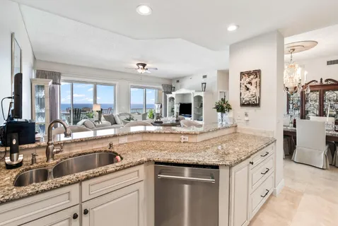 a kitchen with stainless steel appliances kitchen island granite countertop a refrigerator and microwave