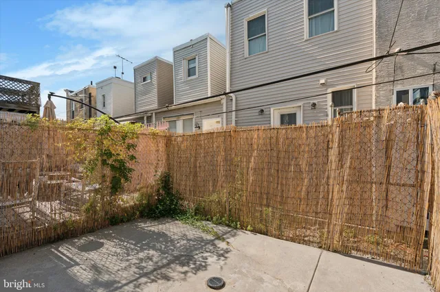 a view of a brick house with many windows