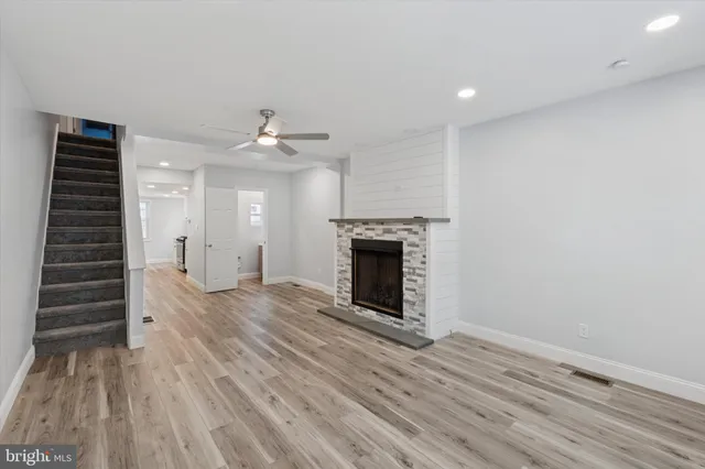 wooden floor in an empty room with a fireplace