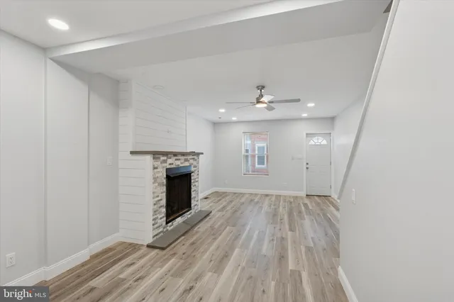 wooden floor in an empty room with a fireplace