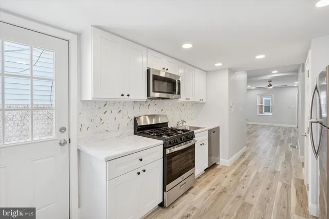 a kitchen with a stove a sink and a microwave